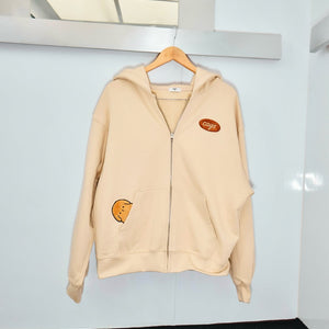 Image of the Caysroom Happy Hoodie hanging on a clotheshanger

