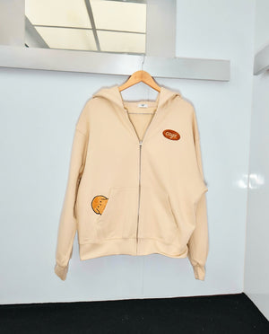 Image of the Caysroom Happy Hoodie hanging on a clotheshanger
